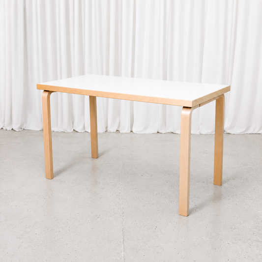 Classic Artek table by Alvar Aalto with a white laminate top and natural birch legs. Good used condition. Dimensions 120 × 60 × 71 cm.