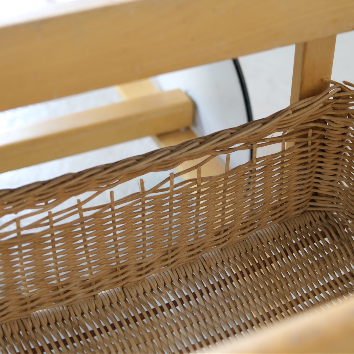 Broken weaving along the upper edge of the rattan basket