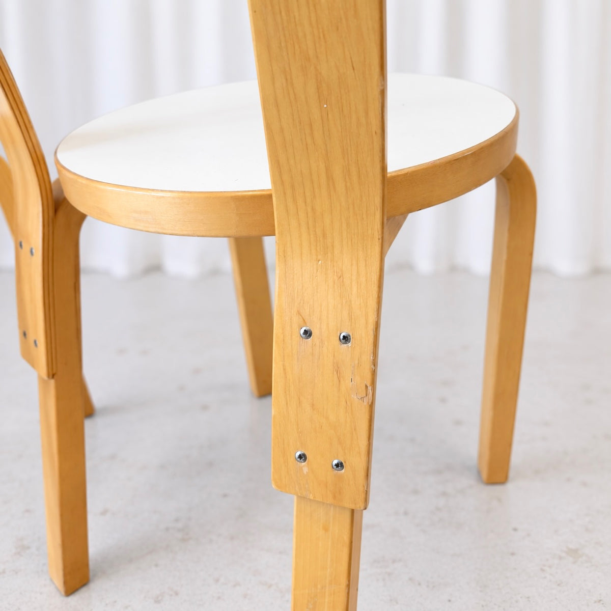 Rear detail of an Artek Chair 66 showing wear and backrest fixings