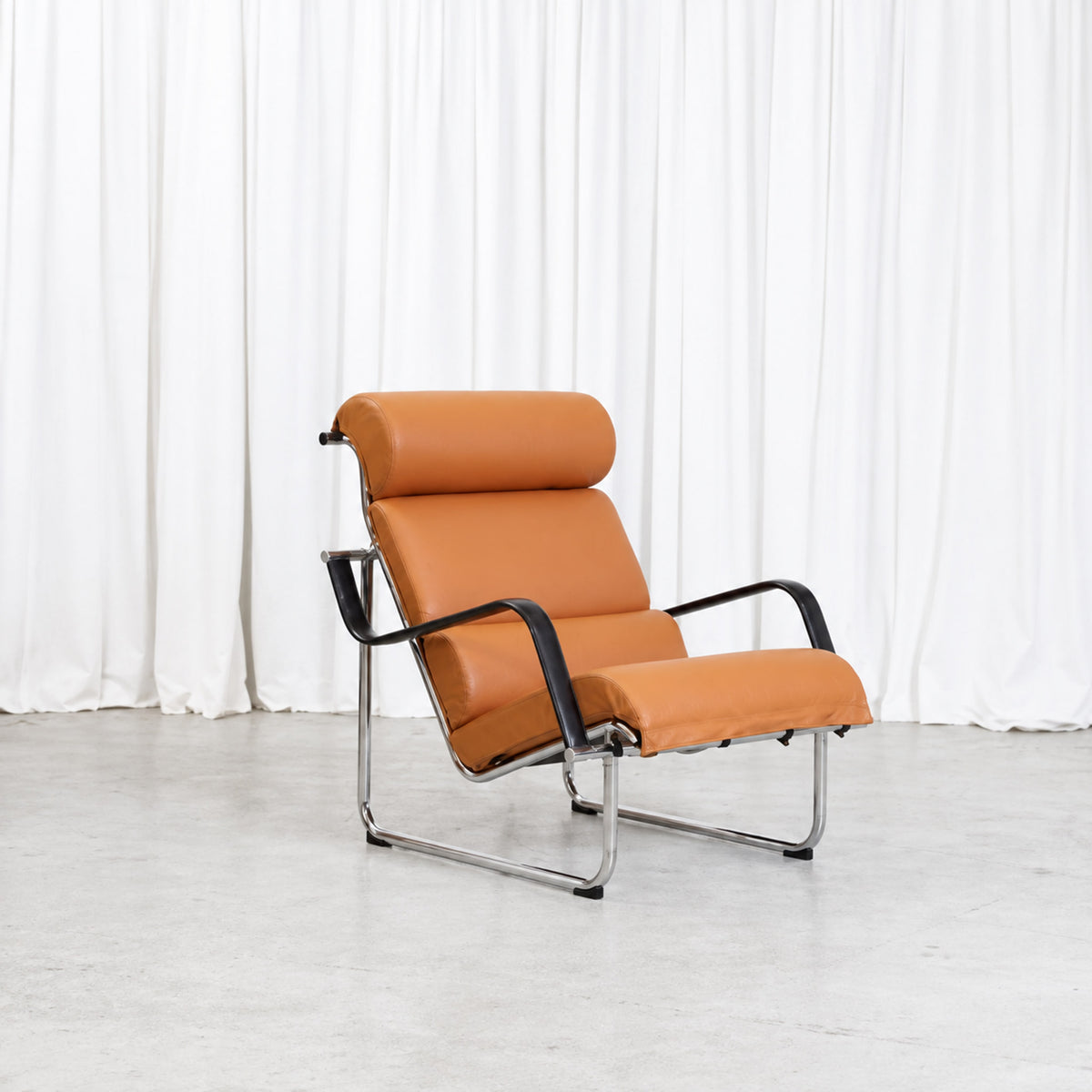 Yrjö Kukkapuro Remmi lounge chair in cognac leather, front three-quarter view