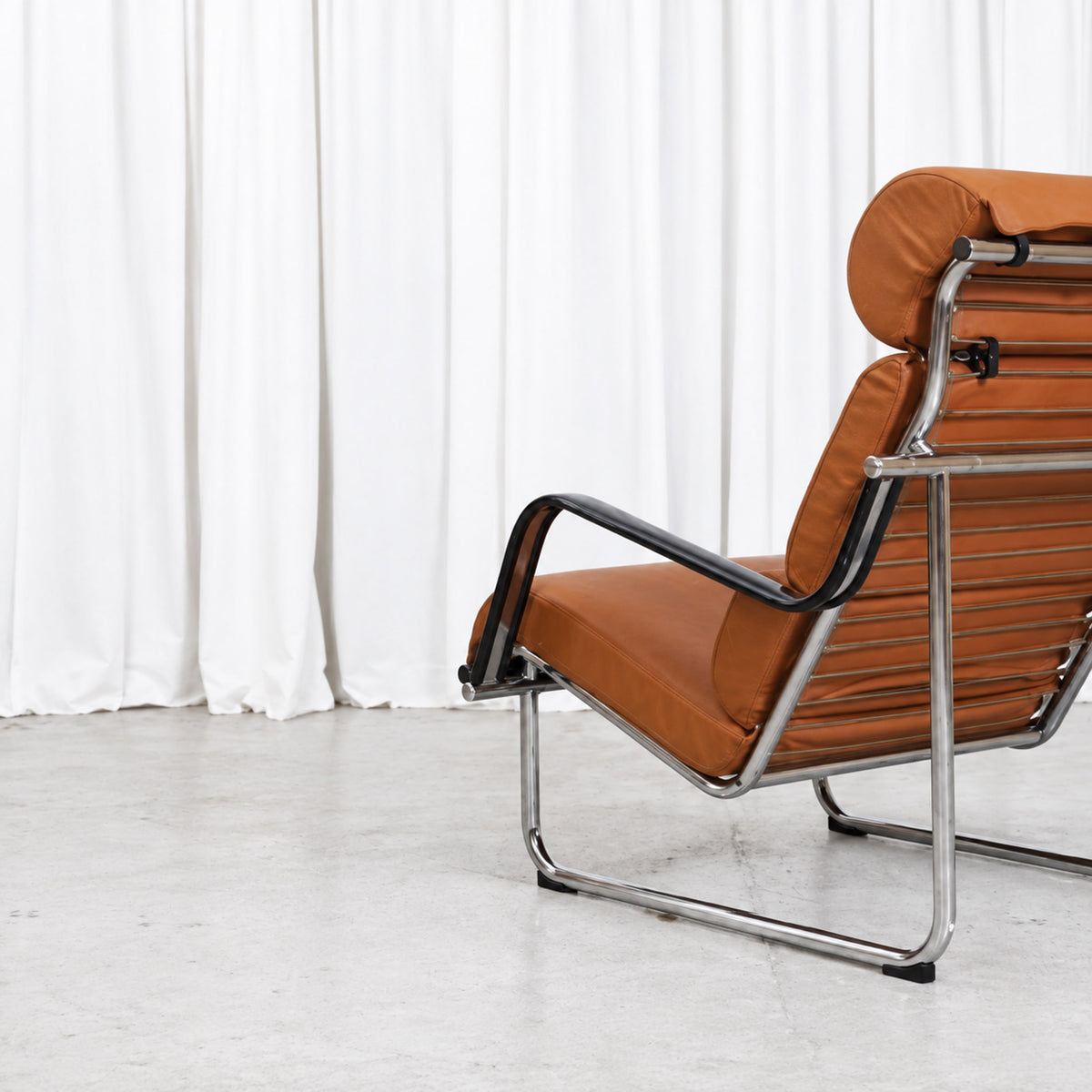 Detail of the chrome frame and cognac leather upholstery on a Yrjö Kukkapuro Remmi chair